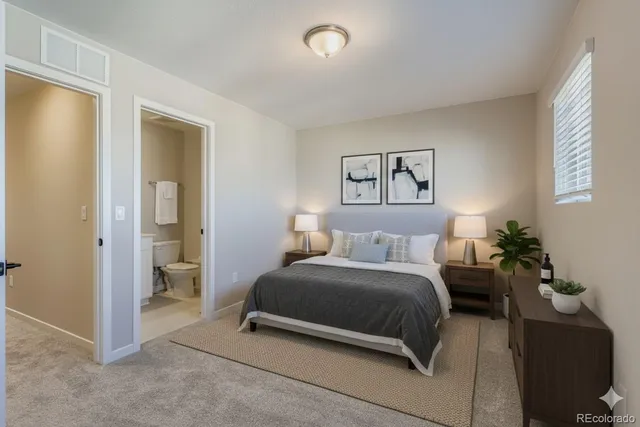 a bedroom with a bed and a painting on the wall