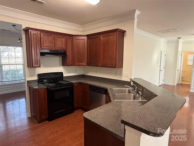 a kitchen with granite countertop a stove and a sink