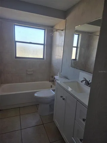 a bathroom with a sink a toilet and tub