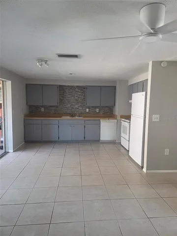 a large kitchen with a stove a refrigerator and a sink