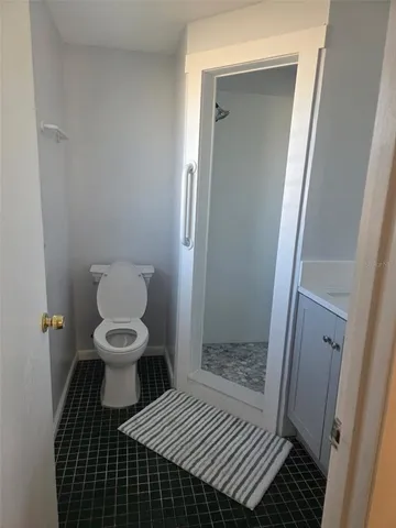 a bathroom with a toilet and a shower