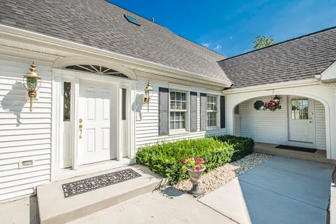 a front view of a house with garden