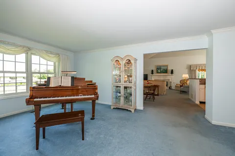 a room with a desk and a piano