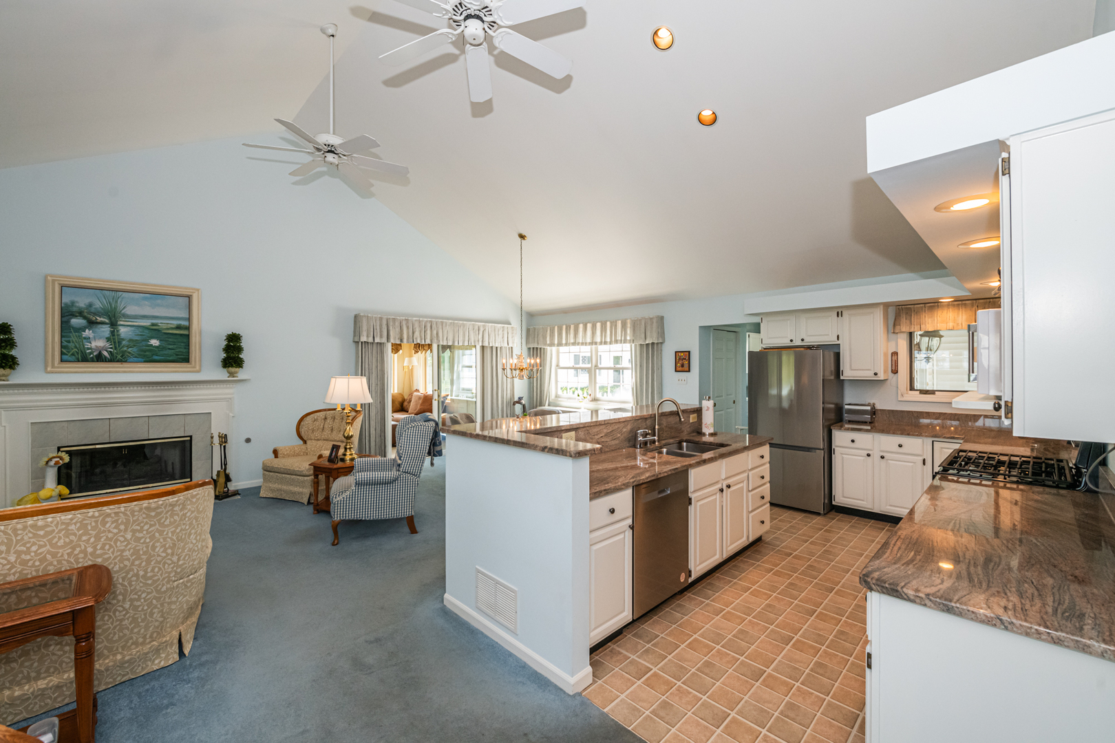 27490 West Wilmot Road Antioch, IL 60002 - Photo 22 of 50 a kitchen with stove a refrigerator and a sink with couches