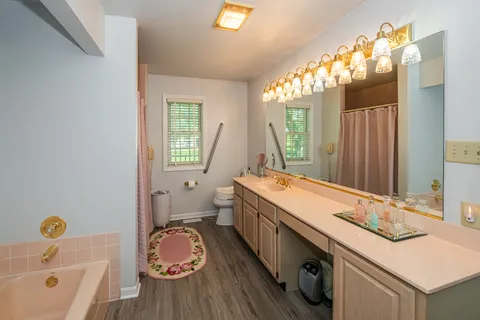 a bathroom with a granite countertop sink and a large mirror