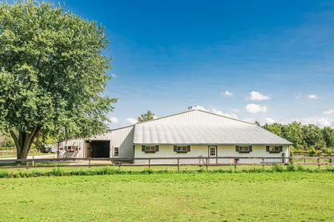 a house with swimming pool in front of it