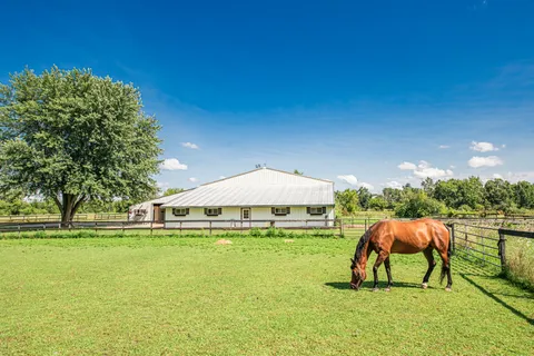 a view of an outdoor space with garden and furniture