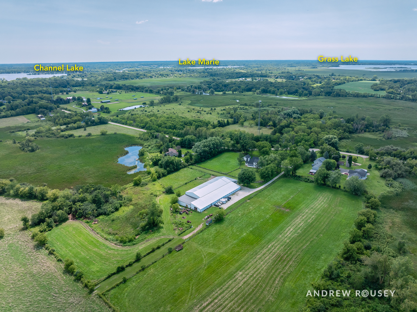 27490 West Wilmot Road Antioch, IL 60002 - Photo 7 of 50 a view of a lush green outdoor space with a swimming pool and valleys in the background