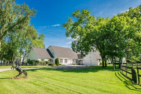 a view of a house with swimming pool and sitting area