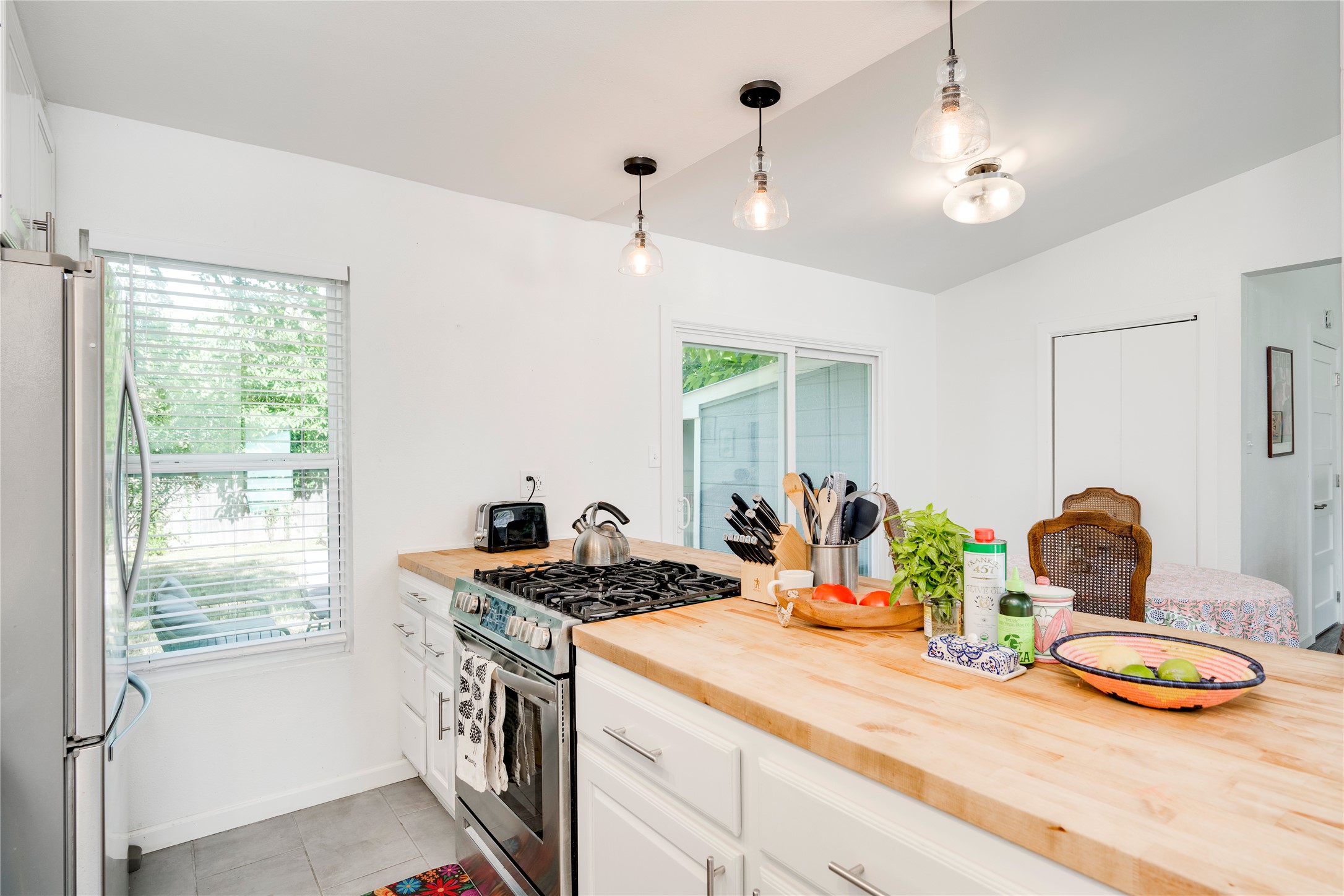 5300 Halmark Drive Austin, TX 78723 - Photo 13 of 40 Culinary delights await in this bright kitchen, complete with natural wood counters and contemporary lighting.