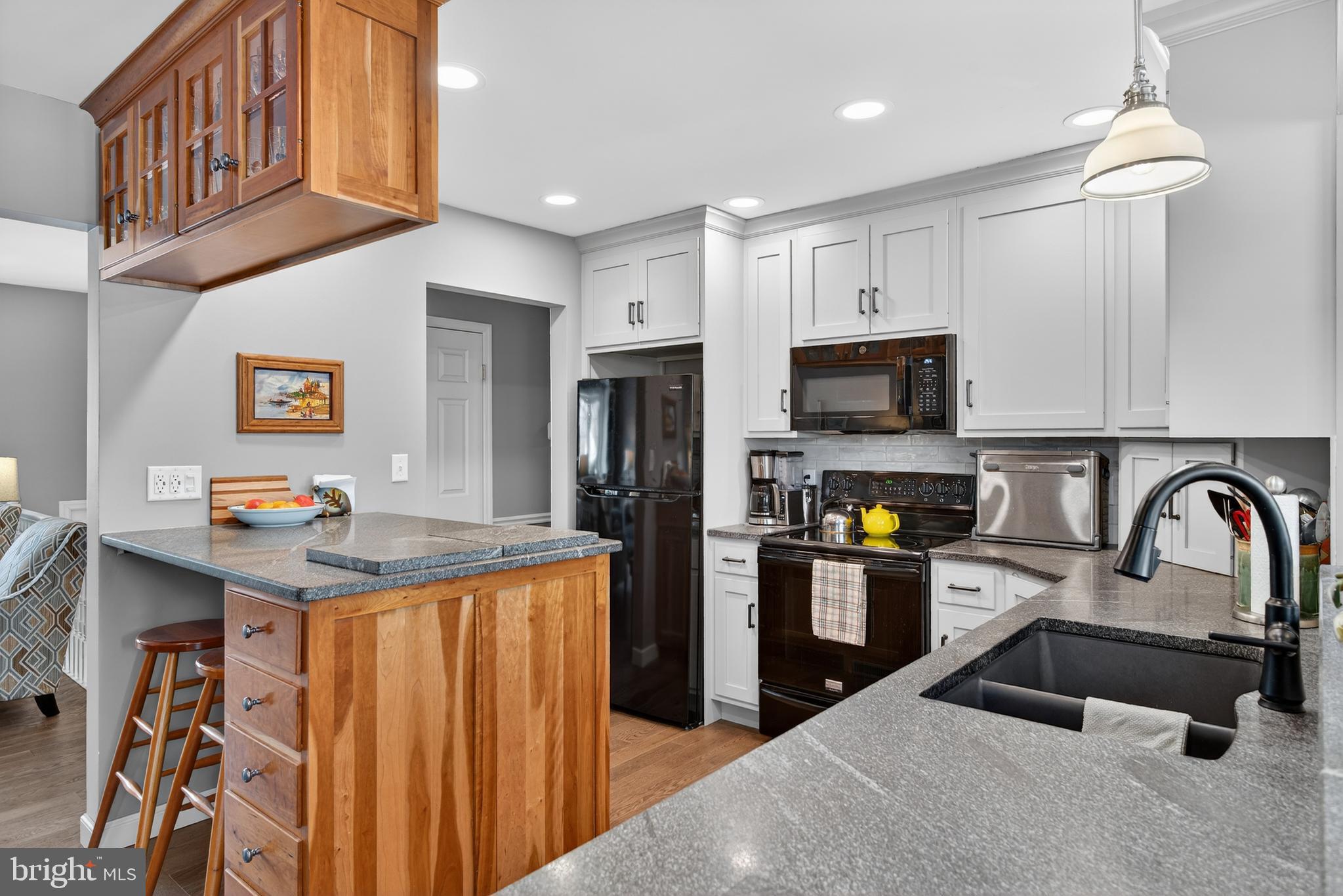 146 South Oak Street Lititz, PA 17543 - Photo 12 of 55 a kitchen with stainless steel appliances granite countertop a stove top oven a sink dishwasher and a refrigerator with wooden floor