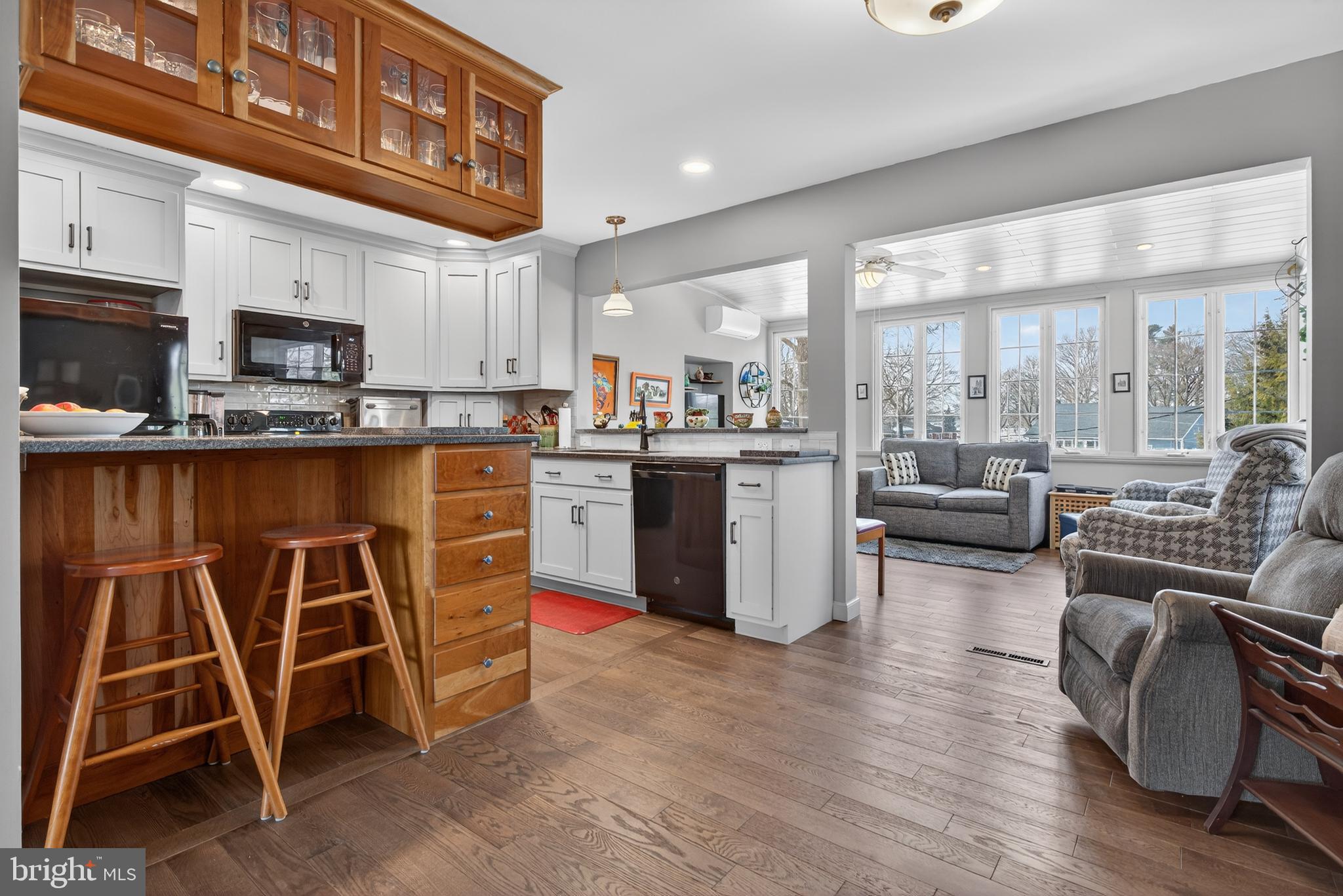 146 South Oak Street Lititz, PA 17543 - Photo 10 of 55 a kitchen with stainless steel appliances granite countertop a stove top oven a sink dishwasher a dining table and chairs with wooden floor