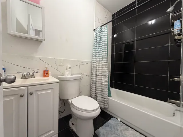a bathroom with a toilet and a bathtub