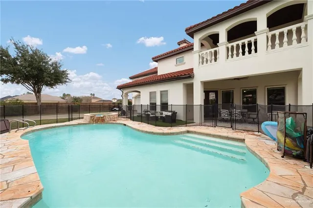 a view of a house with swimming pool having outdoor seating