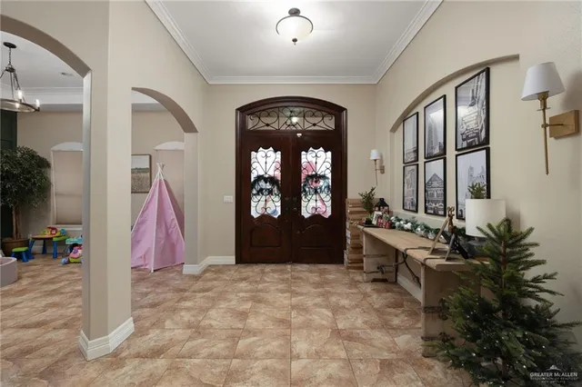 a living room with furniture and large windows