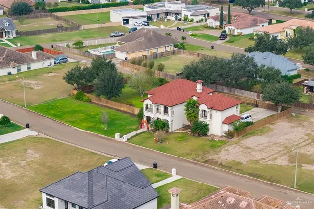 an aerial view of residential houses with outdoor space and river