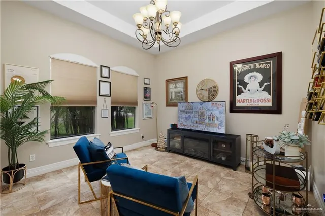 a living room with furniture and a chandelier