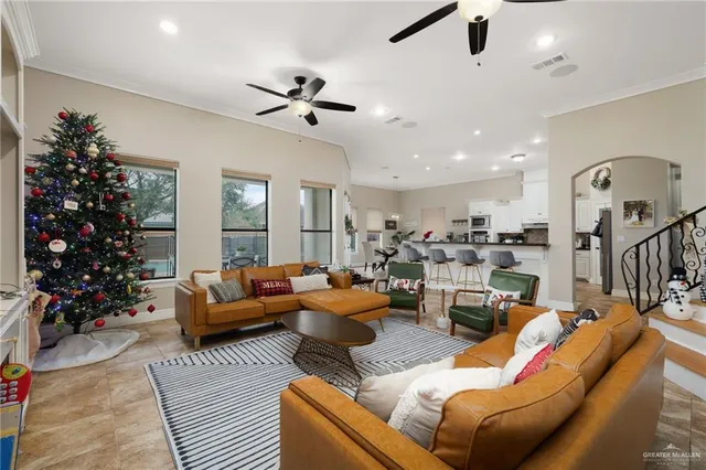 a living room with furniture potted plant and a chandelier