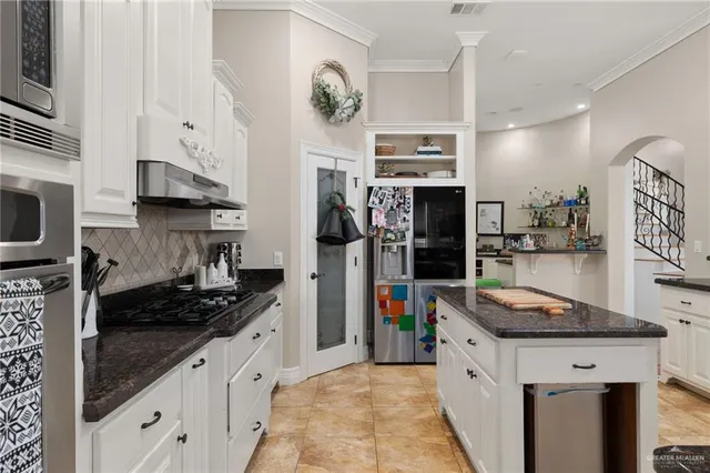 a kitchen with stainless steel appliances granite countertop a stove and a sink