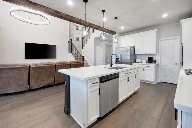 a kitchen with a sink and a stove top oven