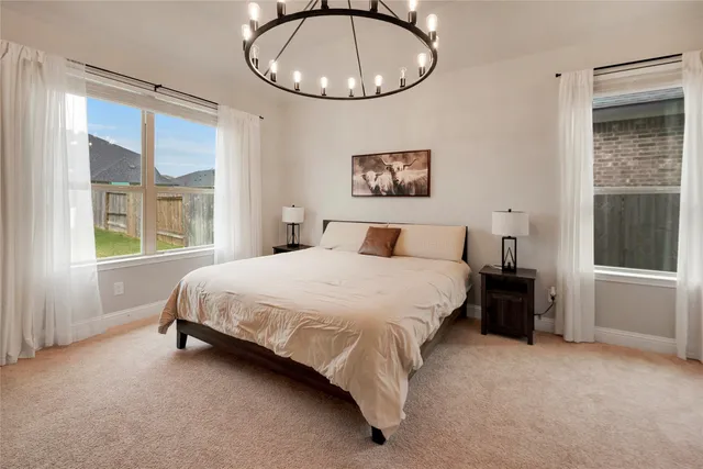 a bedroom with a bed and a painting on the wall