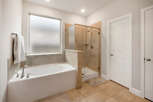 a bathroom with a bathtub and a shower