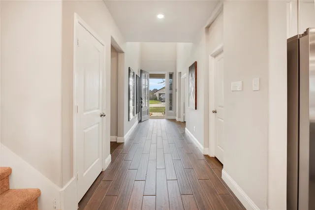 a view of hallway with wooden floor