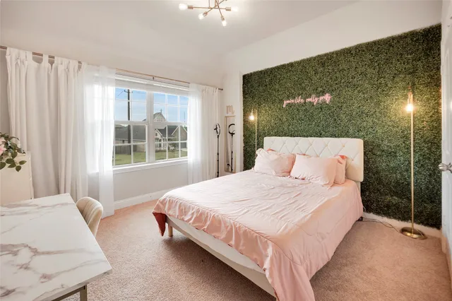 a bedroom with a bed lamp and window