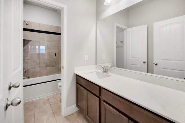 a bathroom with a sink a mirror and shower