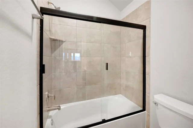 a bathroom with a glass shower door