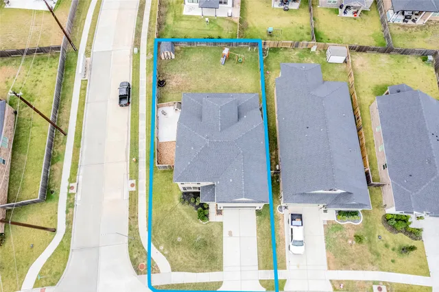 an aerial view of a house with a swimming pool