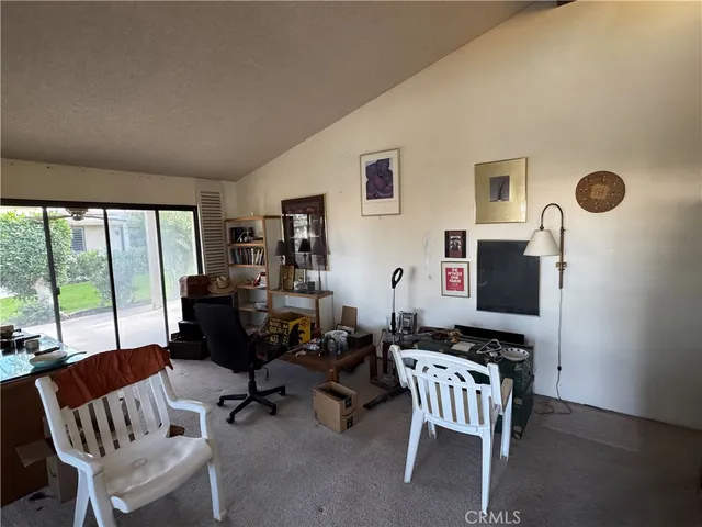 a living room with furniture and a floor to ceiling window