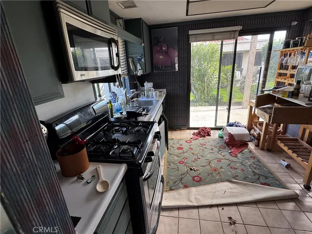 a living room with fireplace furniture and a floor to ceiling window
