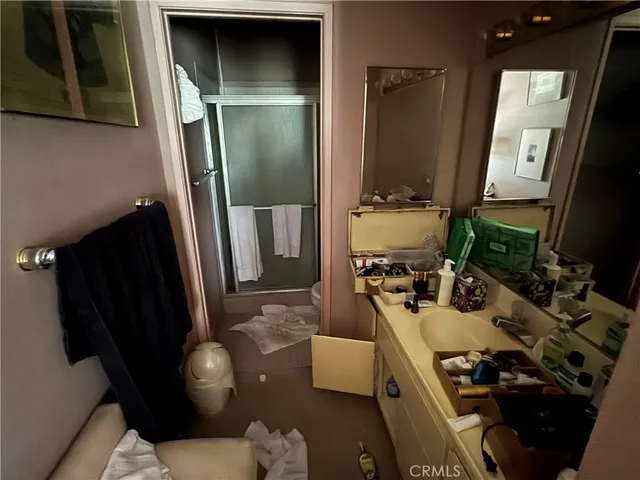 a bathroom with a sink a mirror and shower