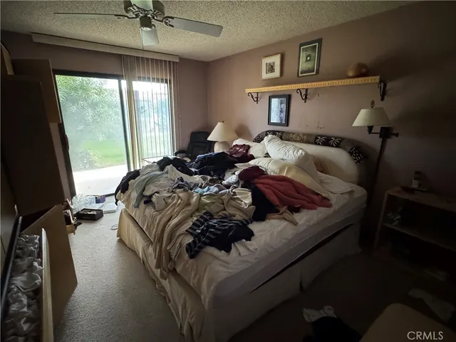 a bed sitting in a bedroom next to a window