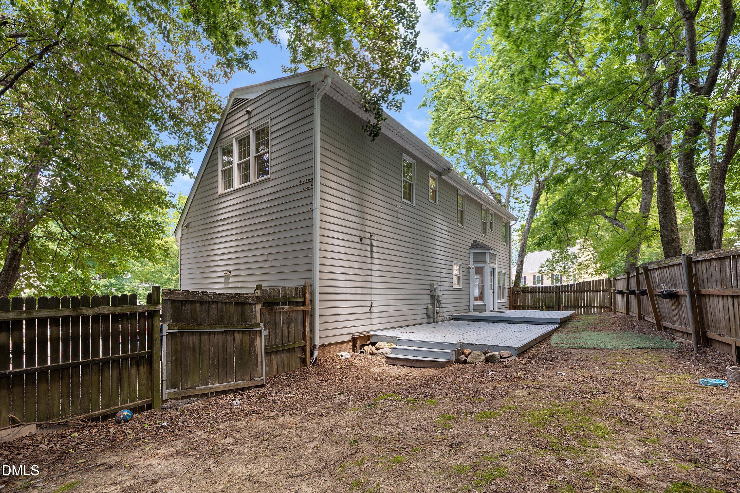 2517 Birchford Court Raleigh, NC 27604 - Photo 58 of 63 a backyard of a house with barbeque oven table and chairs