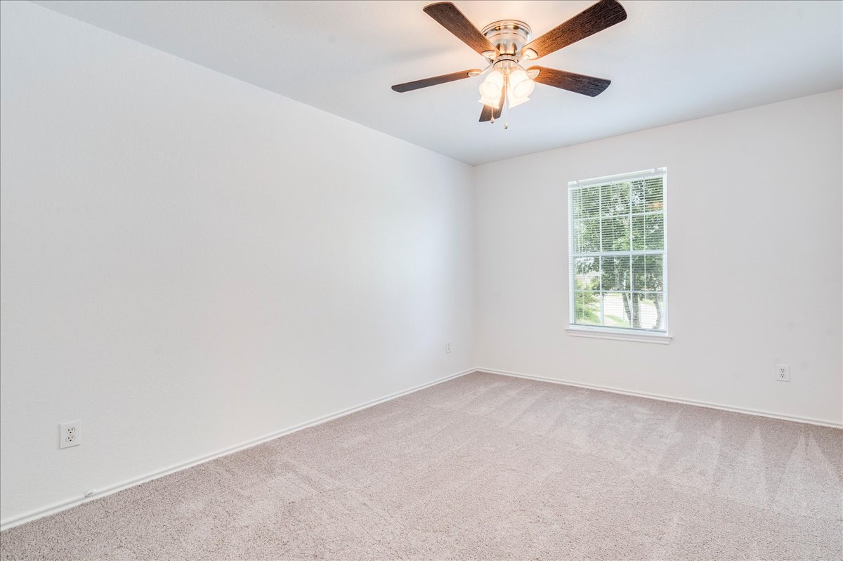 618 Lavaca Loop Elgin, TX 78621 - Photo 19 of 30 Unfurnished room with carpet flooring and ceiling fan