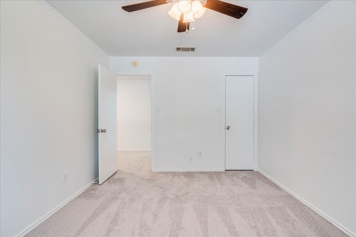 618 Lavaca Loop Elgin, TX 78621 - Photo 20 of 30 Unfurnished bedroom featuring light carpet and ceiling fan