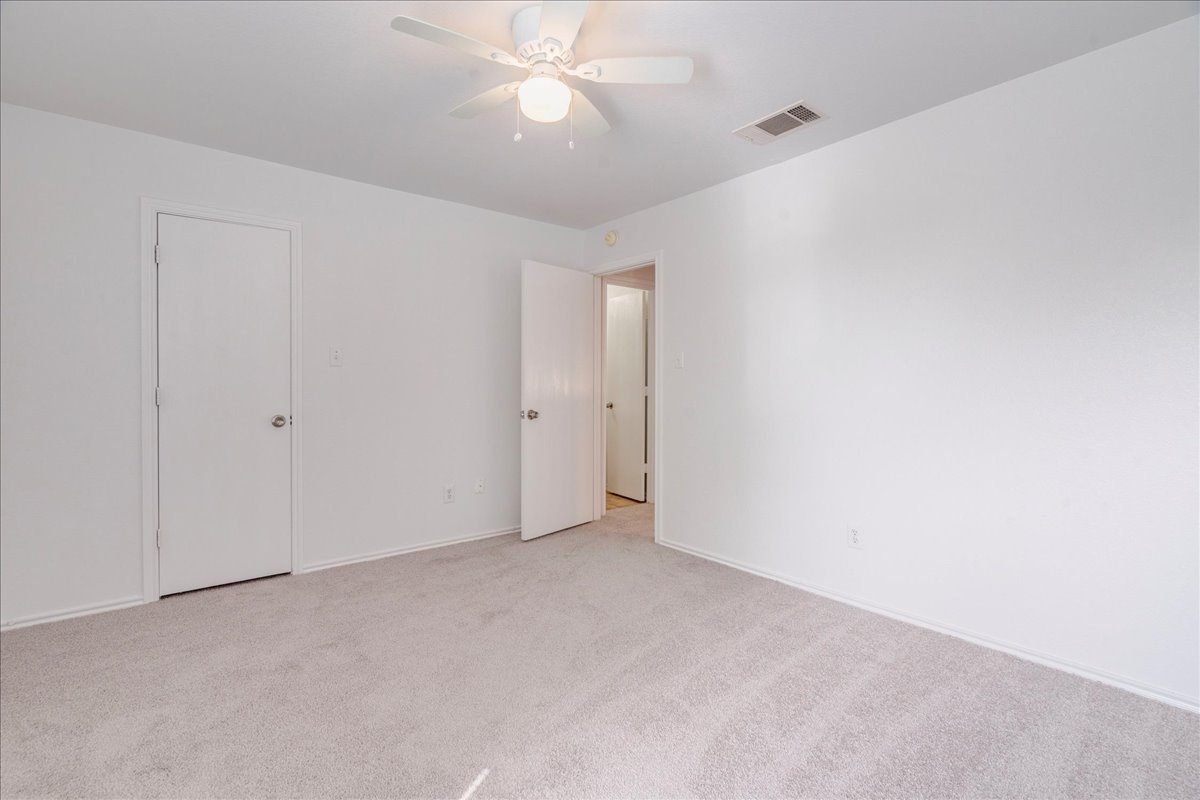 618 Lavaca Loop Elgin, TX 78621 - Photo 22 of 30 Unfurnished bedroom featuring light colored carpet and a ceiling fan