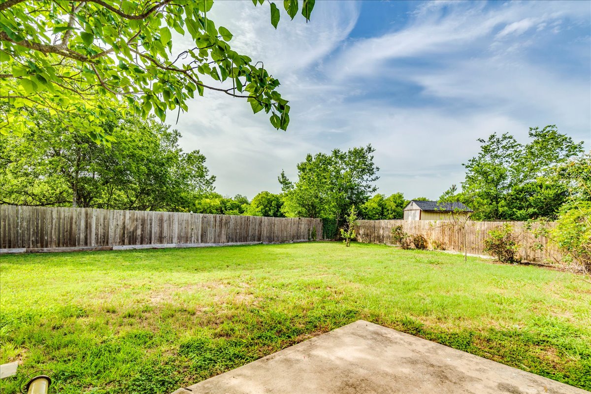 618 Lavaca Loop Elgin, TX 78621 - Photo 25 of 30 Fenced backyard featuring a patio