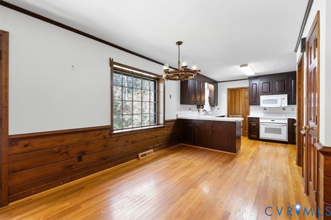 11716 Ivywood Road Chester, VA 23831 - Photo 13 of 38 a kitchen with stainless steel appliances kitchen island granite countertop a sink dishwasher a stove and a wooden floor