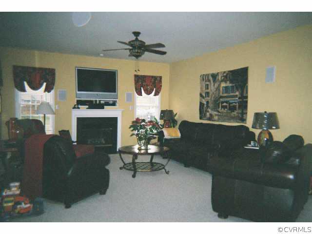 1113 Goswick Ridge Road Midlothian, VA 23114 - Photo 5 of 5 a living room with furniture rug and a fireplace