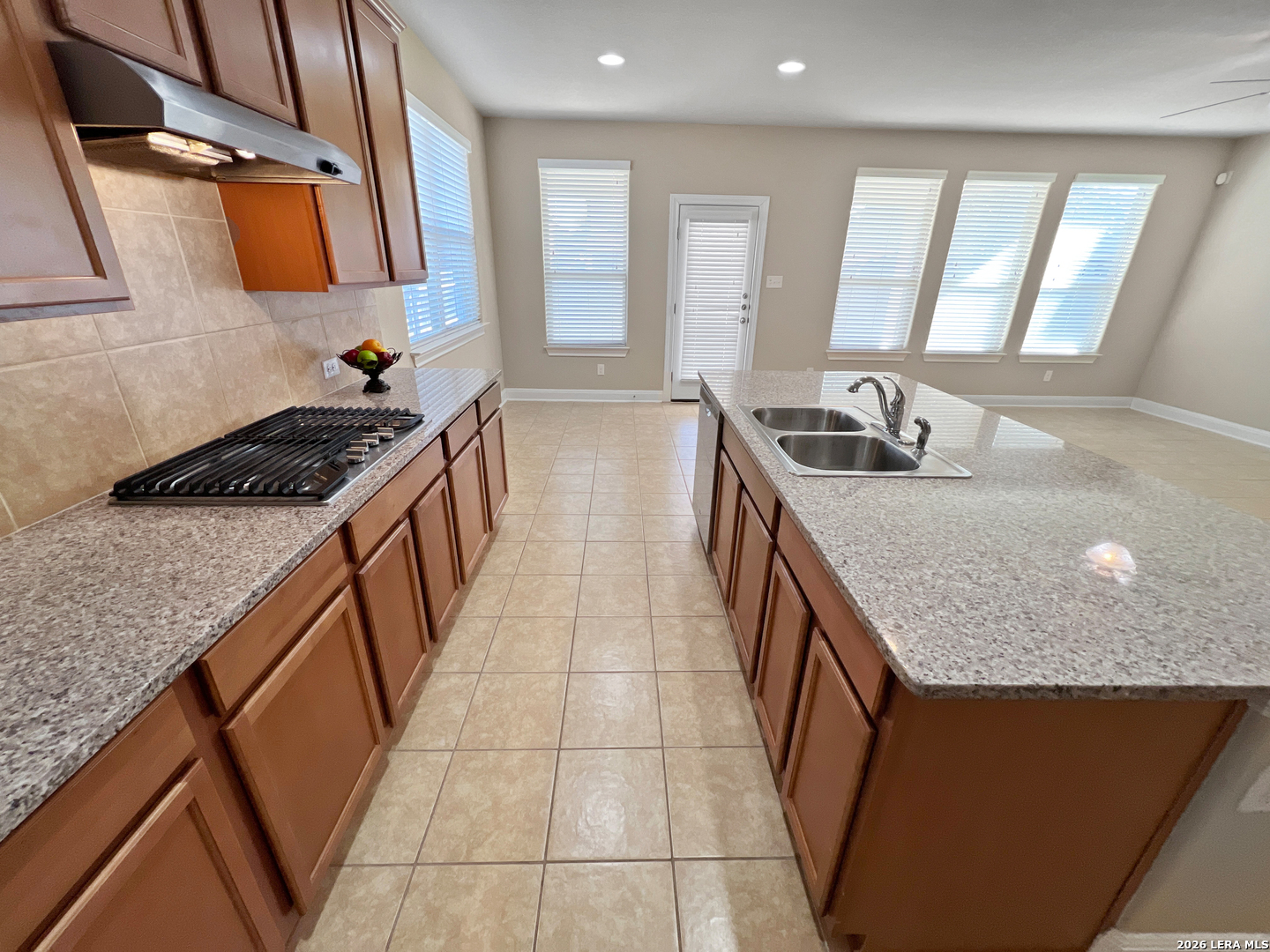 8626 Jogeva Rise San Antonio, TX 78251 - Photo 24 of 44 a kitchen with stainless steel appliances granite countertop a sink stove and cabinets