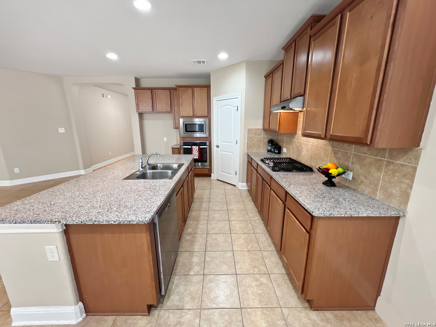 8626 Jogeva Rise San Antonio, TX 78251 - Photo 27 of 44 a large kitchen with granite countertop a sink and cabinets
