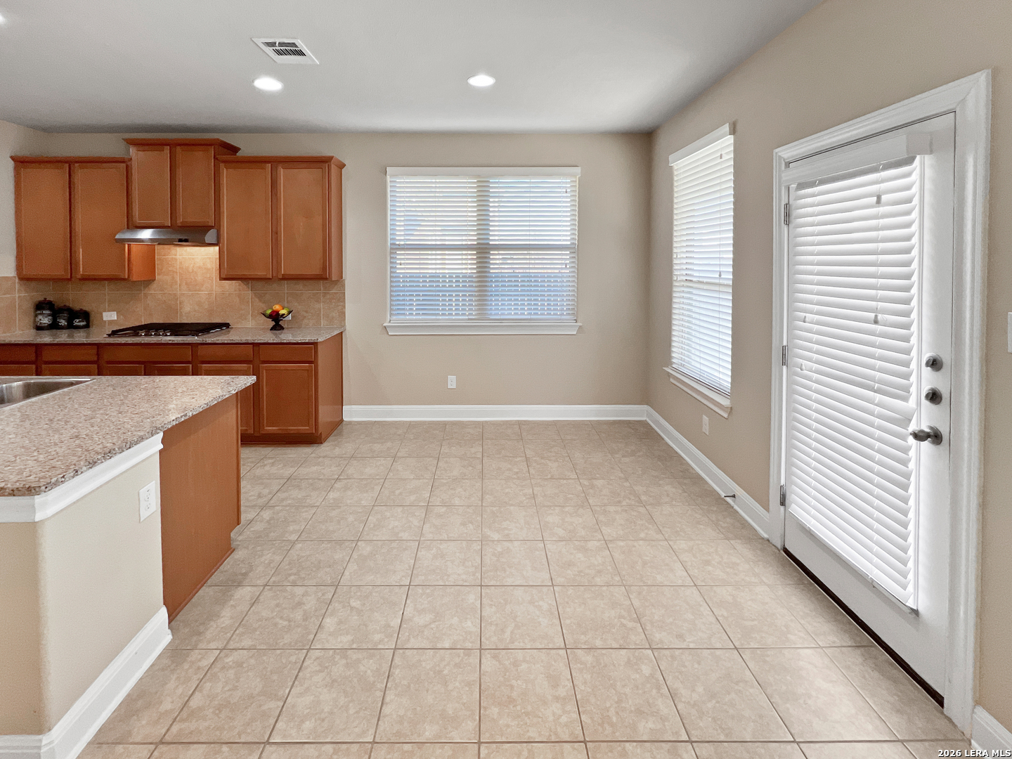 8626 Jogeva Rise San Antonio, TX 78251 - Photo 29 of 44 a large kitchen with stainless steel appliances granite countertop a stove a sink and a granite counter tops