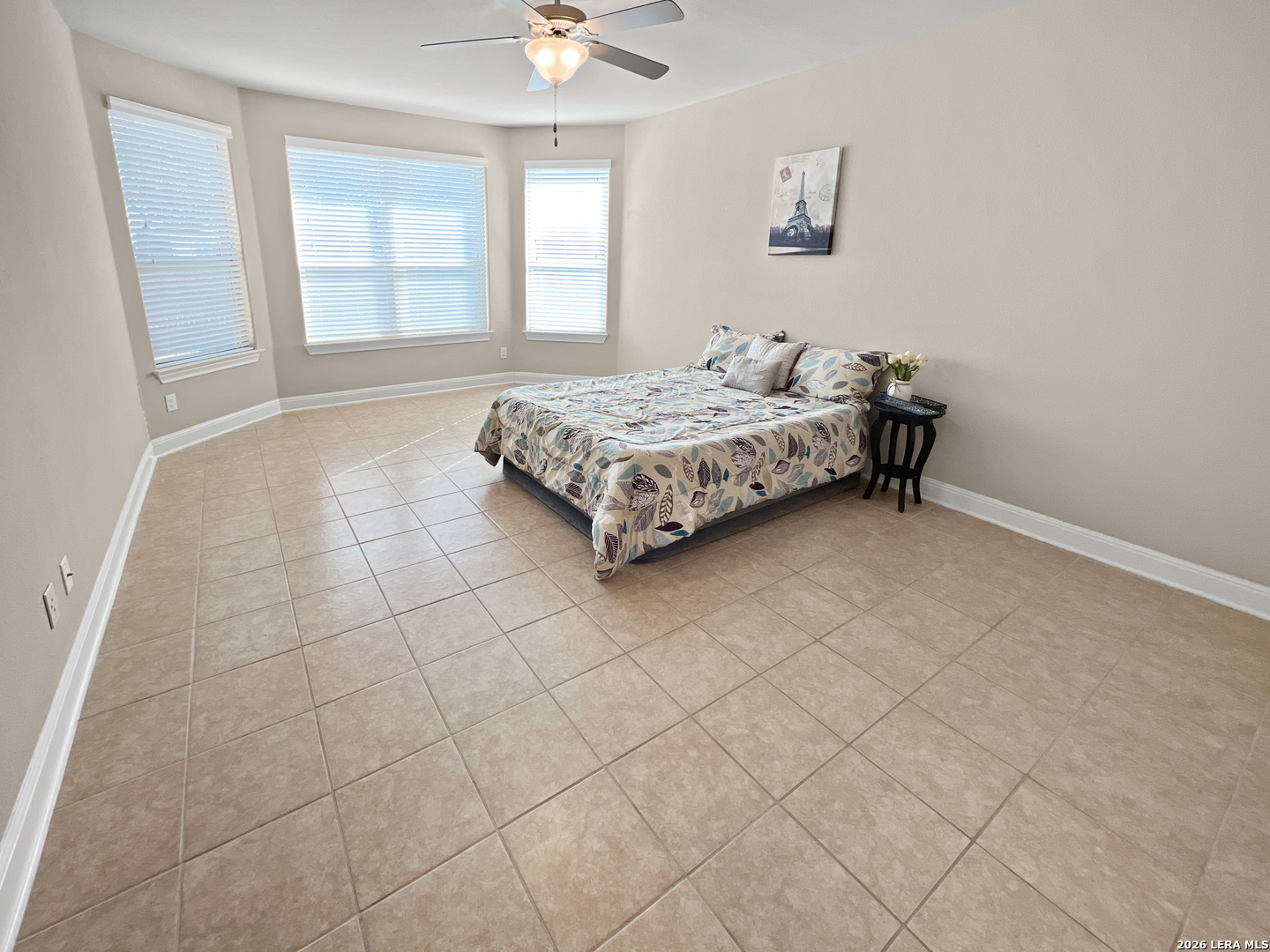 8626 Jogeva Rise San Antonio, TX 78251 - Photo 31 of 44 a spacious bedroom with a bed and a window in it