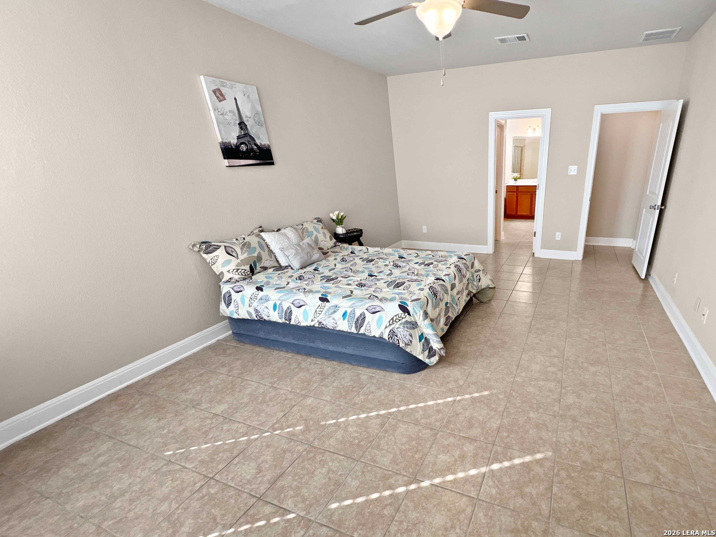 8626 Jogeva Rise San Antonio, TX 78251 - Photo 33 of 44 a bedroom with a bed and a chandelier