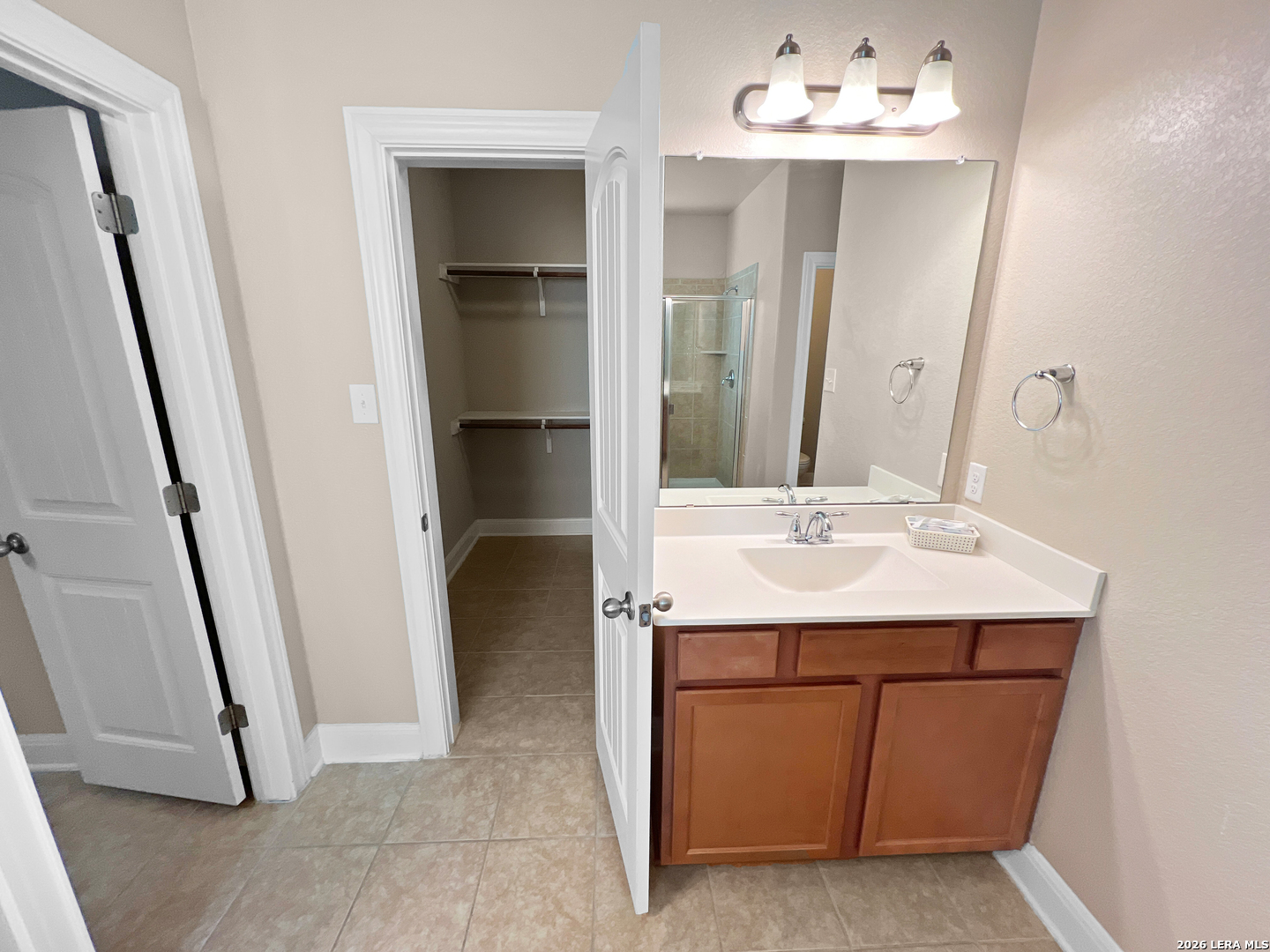 8626 Jogeva Rise San Antonio, TX 78251 - Photo 39 of 44 a bathroom with a sink a mirror and a light fixture