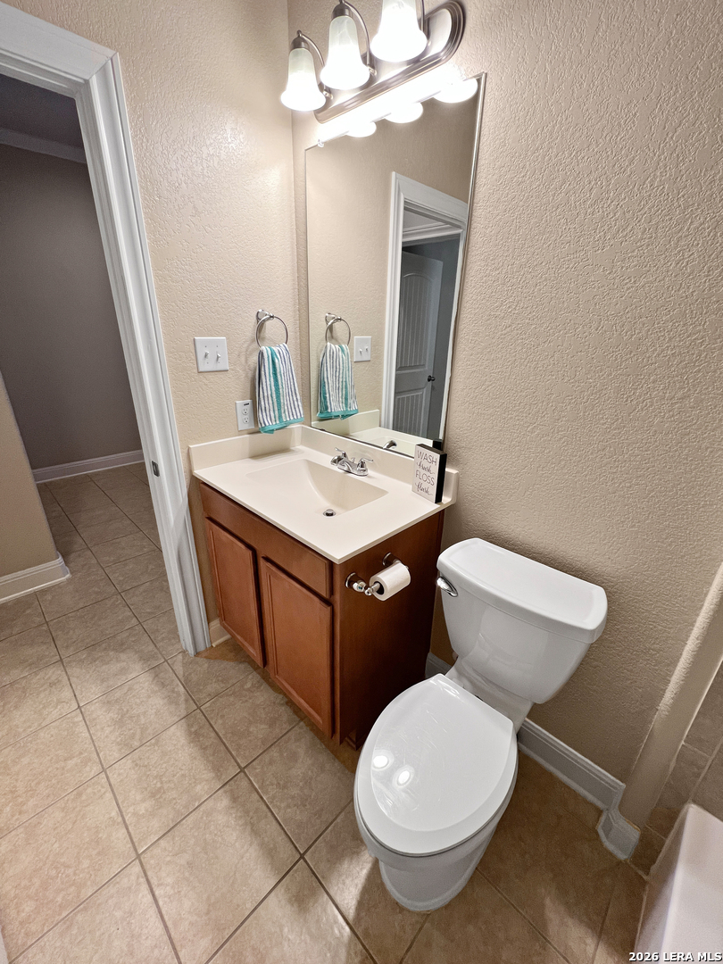 8626 Jogeva Rise San Antonio, TX 78251 - Photo 7 of 44 a bathroom with a toilet a sink and a mirror