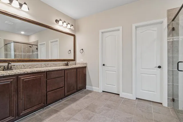 a spacious bathroom with a granite countertop sink and a mirror